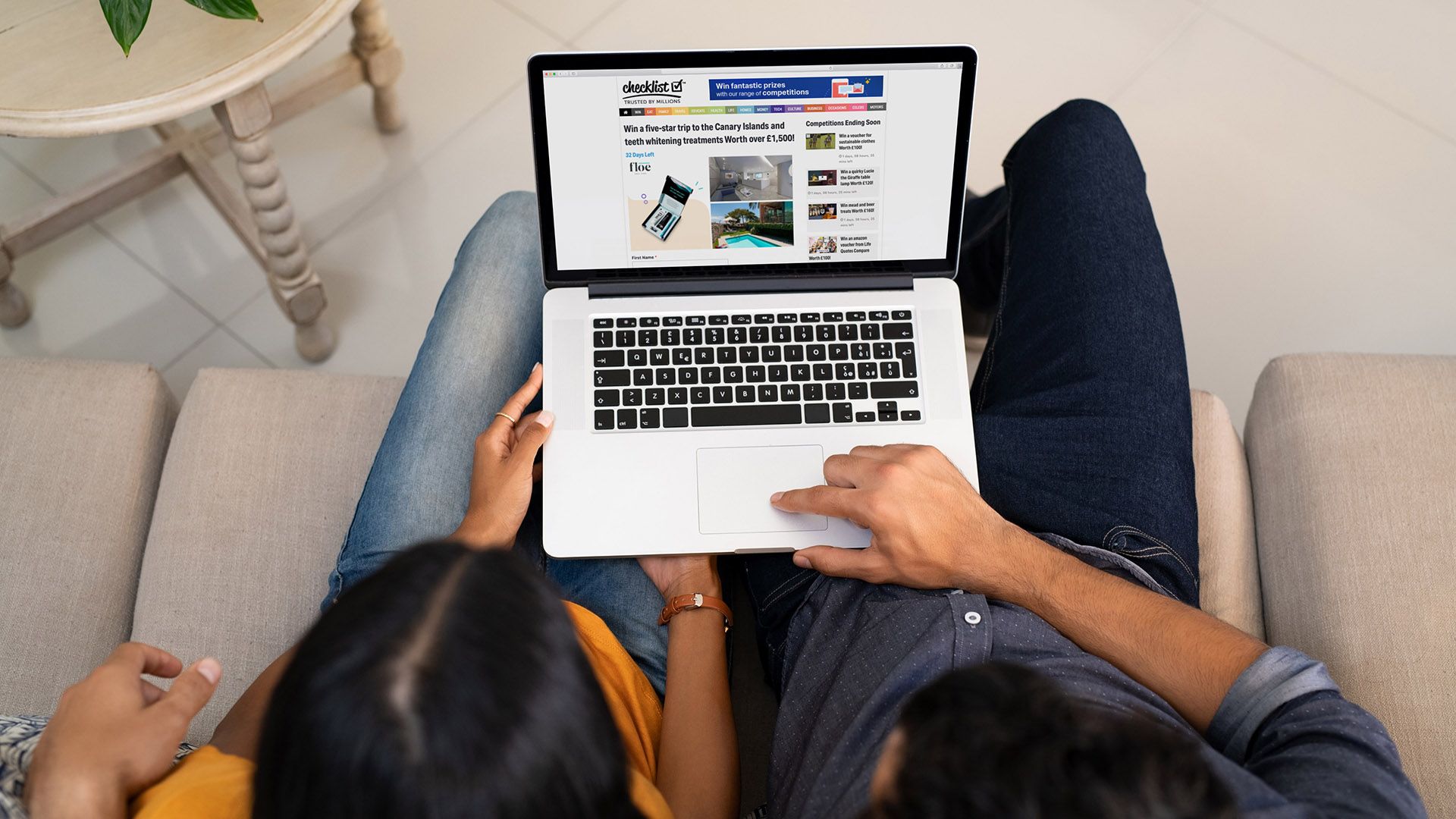 couple viewing a Checklist competition on a laptop