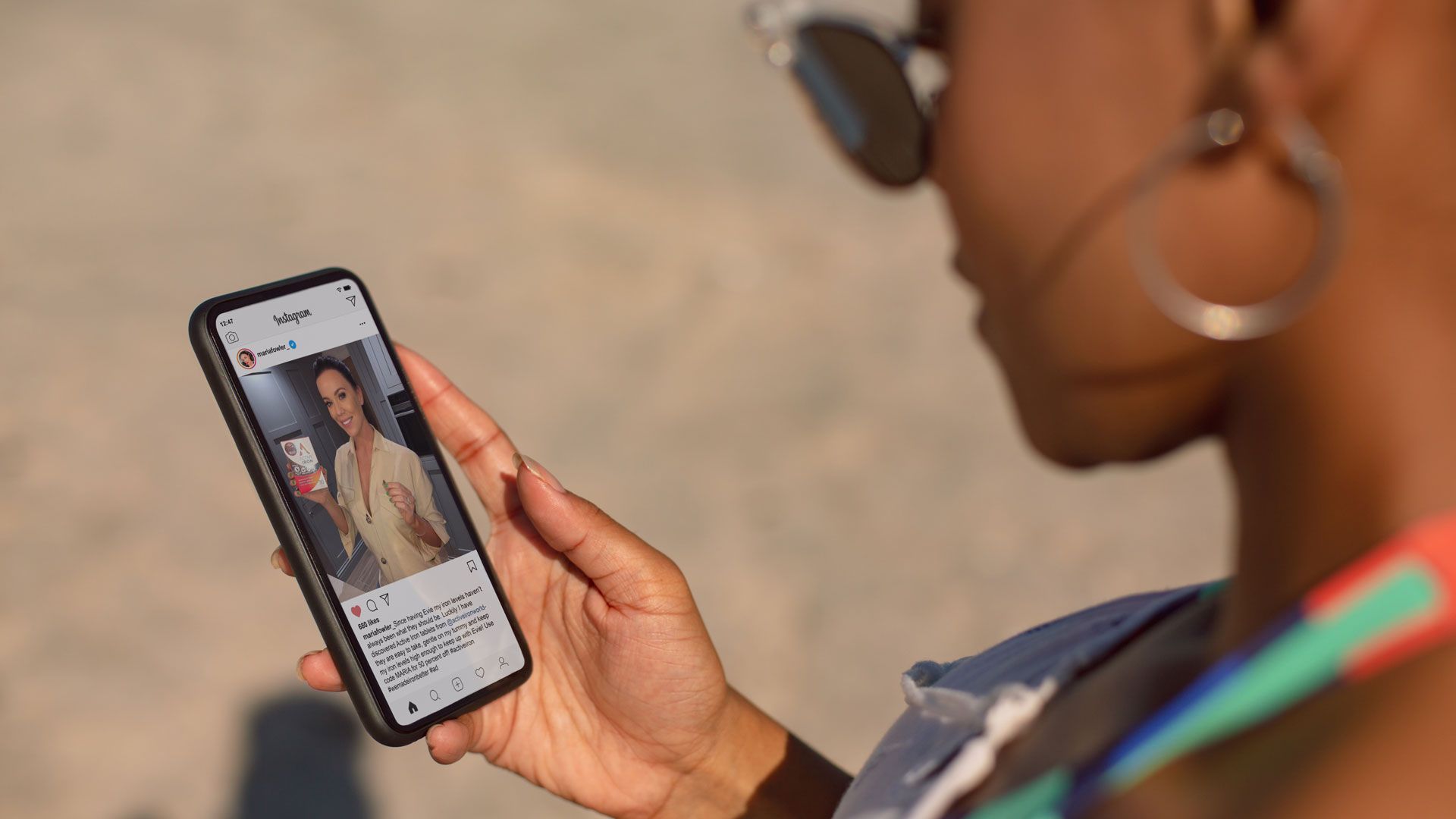 woman viewing a product endorsement on the Celebrity Secrets Instagram on mobile